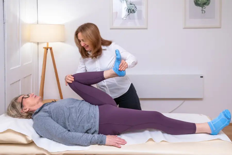 Galina Bell mobilising a patient's hip during an osteopathy appointment