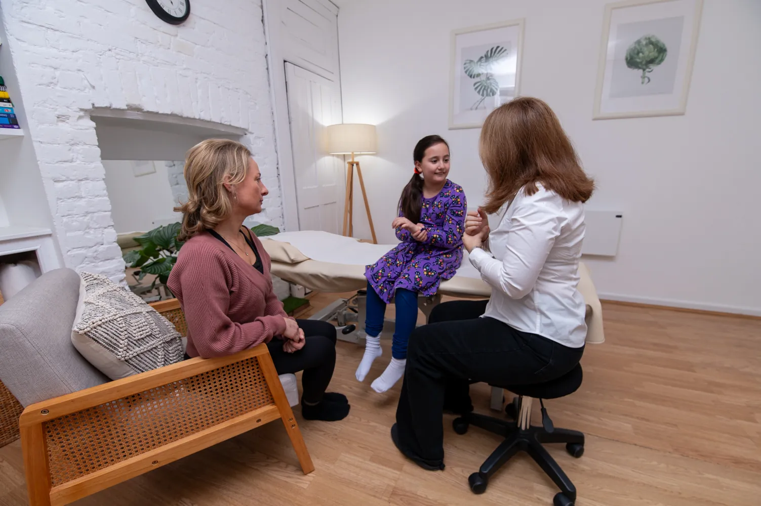 Galina Bell gently assessing a young child during an osteopathy appointment